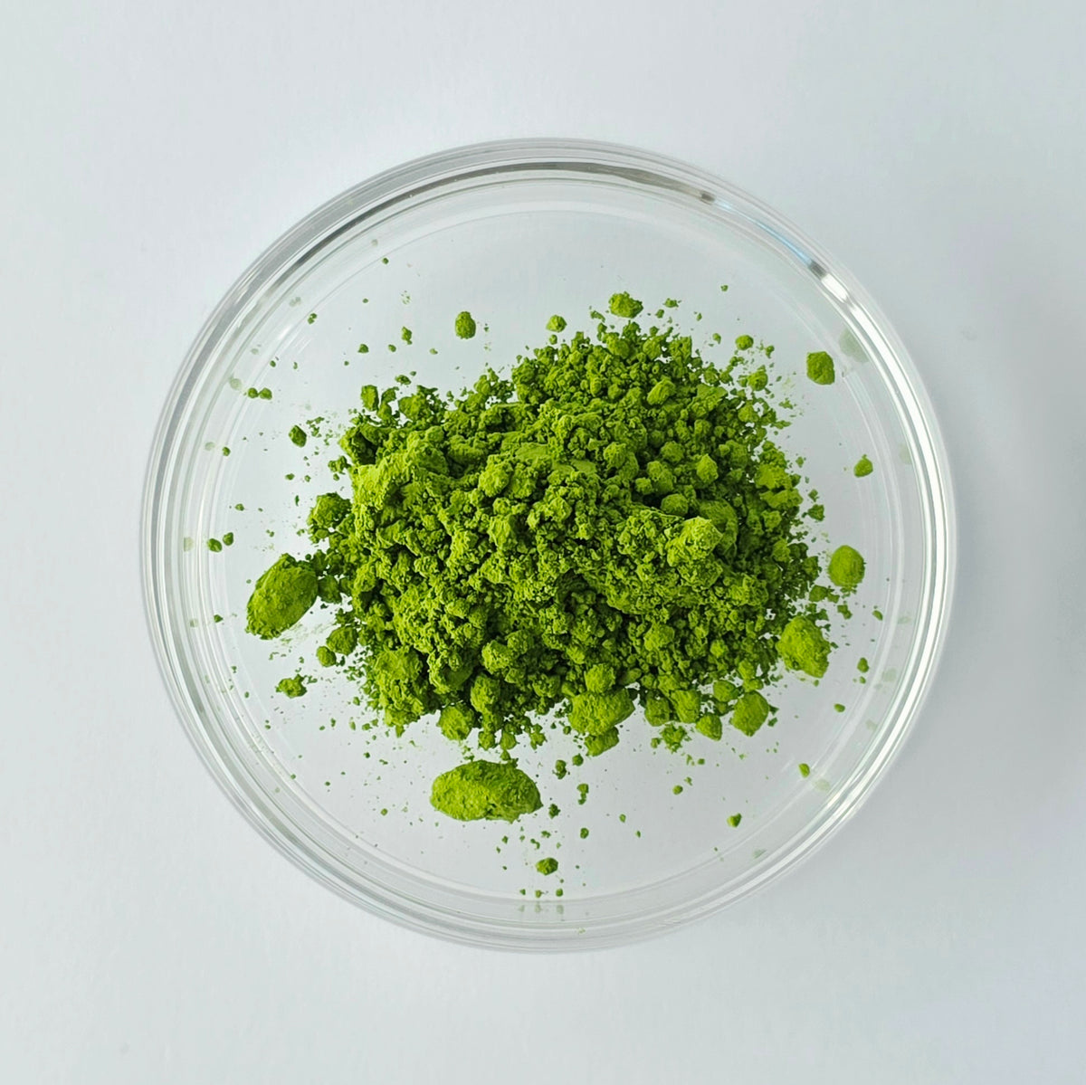 Wabi Matcha Tsubaki Matcha powder in a glass dish on a white background