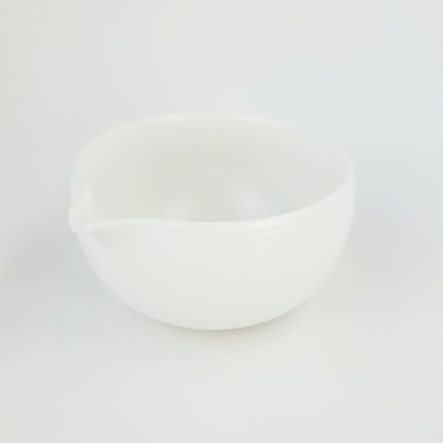 A classic white matcha bowl on a white background