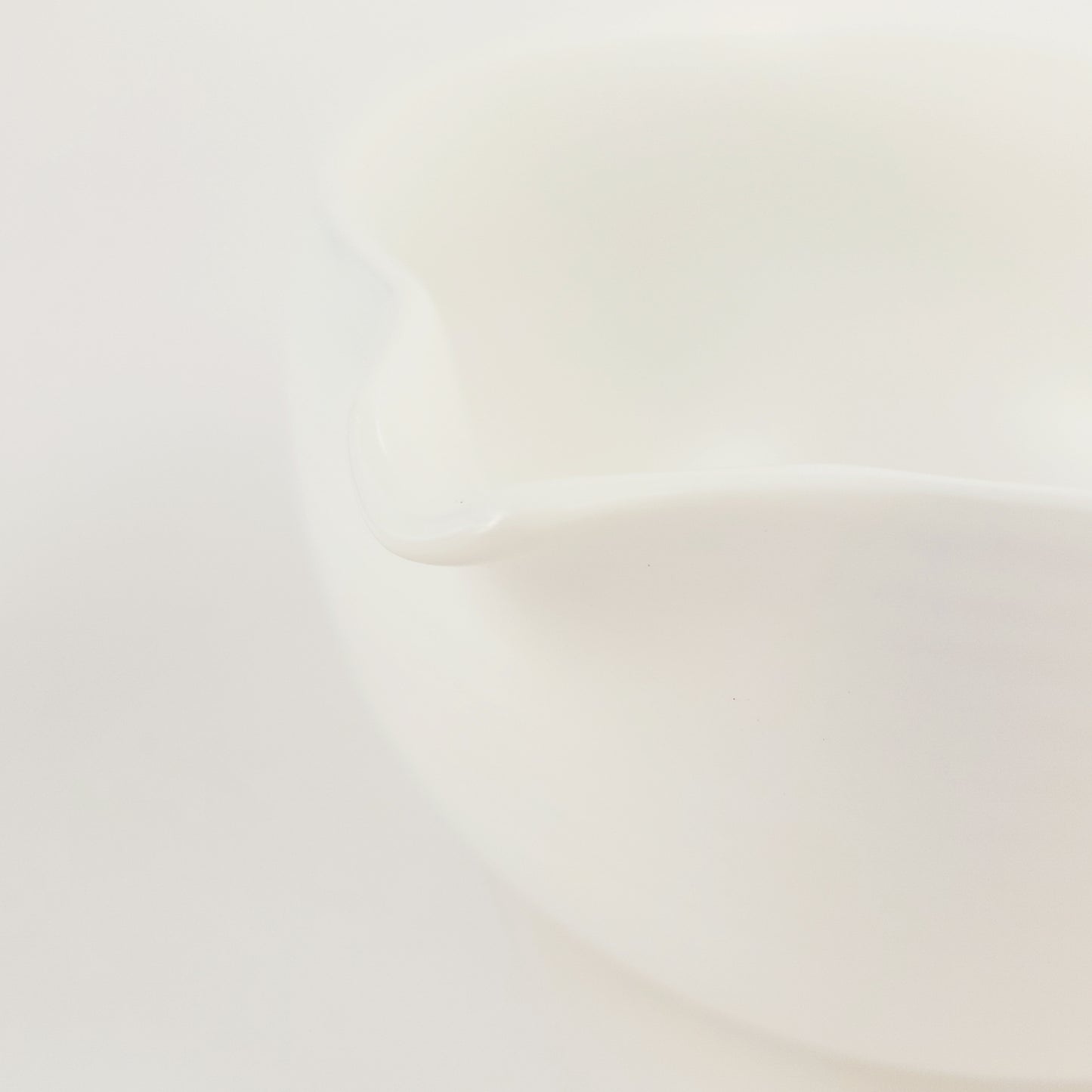 A close-up of the pourer on a classic white matcha bowl