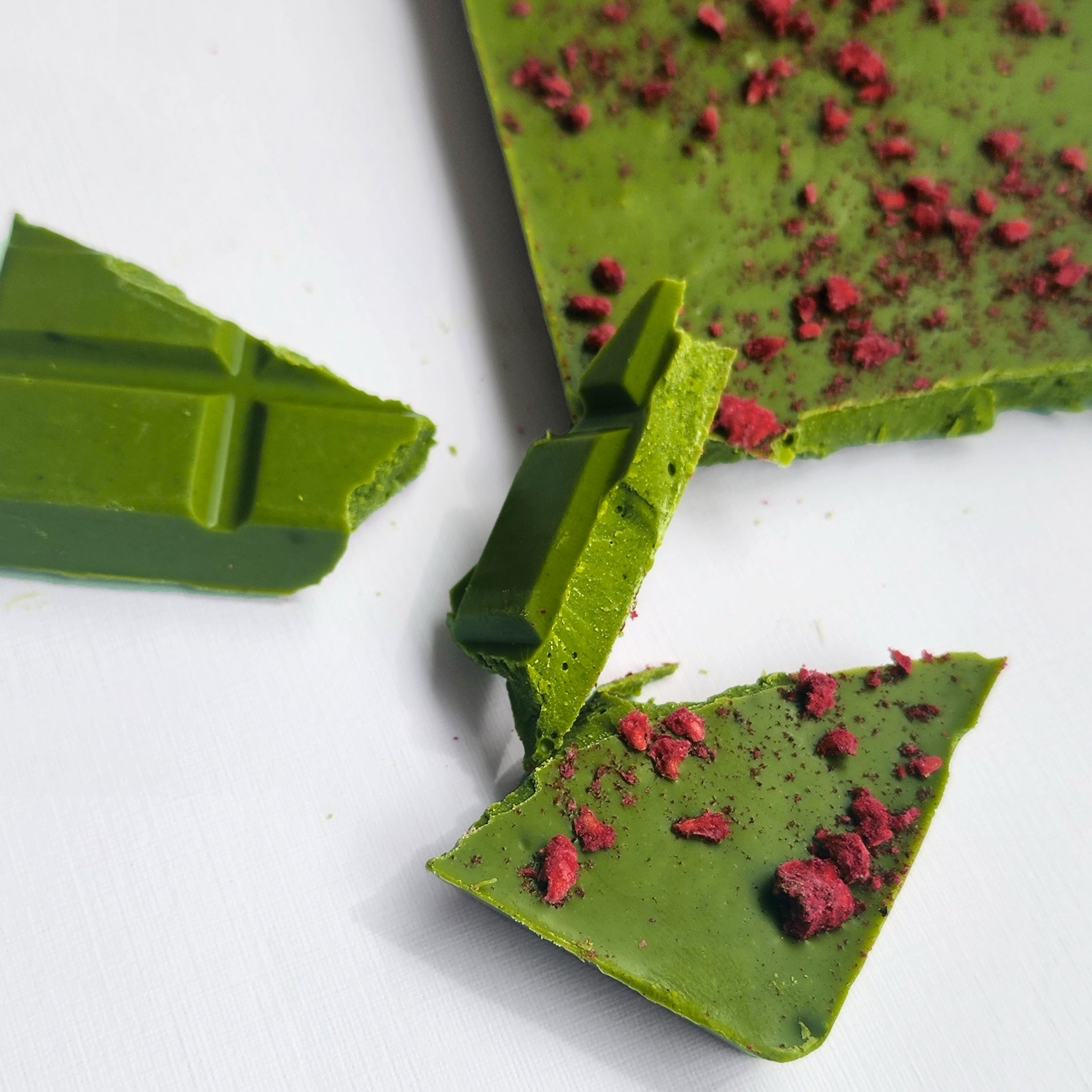 Wabi Matcha Chocolate with freeze dried raspberries broken and ready to eat