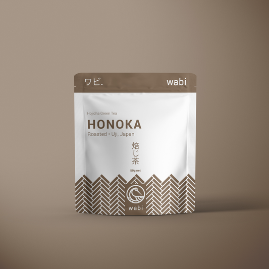 Honoka Roasted Houjicha Powder 50g Pouch - Toasty & Aromatic Japanese Green Tea - on a brown background with gradient